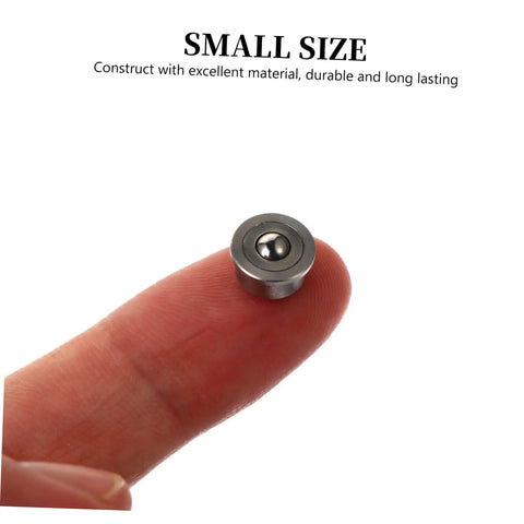 Heavy Duty Steel Ball Transfer Units Set Of 3 Low Profile 360 Degree Rotating Casters on a fingertip showing small size and durability.