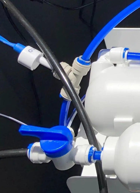 Close-up of blue One Quarter Inch Locking Clips 50 Pack For Reverse Osmosis RO Water Line Quick Connect Fittings installed on system.