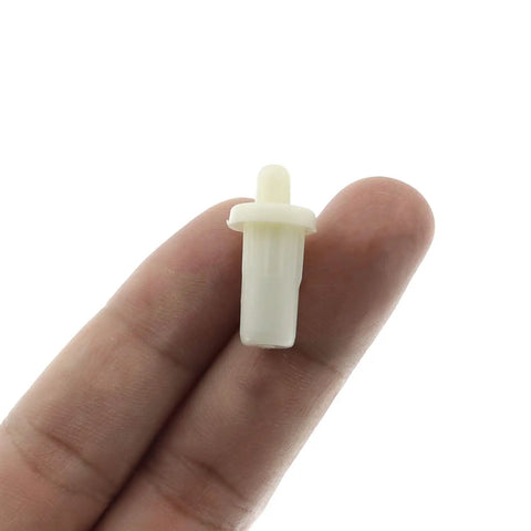 Heavy Duty 20 Pack Cabinet Door Repair Pins With Spring Loaded Damper Design For Smooth Shutter Hinge Replacement Plastic Furniture Fittings At 25Mm Length And 7.5Mm Diameter In Clean White Finish held in hand.