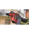 Person using Kwik Bolt Mechanical Setting Tool For 6 Inch Overhead Installations, 1 Count, on concrete with rotary hammer.