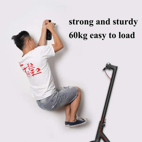 Person installing Heavy Duty Wall Mount Bike And E Scooter Hanger With Padded Tire Grooves No Fuss Install killer garage storage rack.