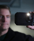 Person holding Pocket Thermal Camera C2 for home and building inspections, capturing thermal images.