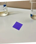 Must Have Set Of 2 Cobalt Glass Sheets 5x5cm for Chemistry Flame Color Reaction Tests, single glass sheet on lab table near beakers