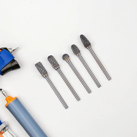 Five tungsten carbide rotary burrs from the 10-Piece Tungsten Carbide Rotary Burr Set With Blue Case For Metal Deburring And Wood Carving High-Precision Grinding And Polishing Bits For CNC Routers Hobbyists And Professionals Tackling Intricate Edges on a white background.