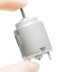 Five Pack Mini DC Motors 1 To 6 Volt High RPM 5000 To 20000 for DIY projects, close-up of one silver motor with 2mm shaft held by fingers.