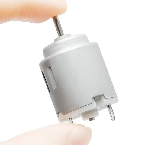 Five Pack Mini DC Motors 1 To 6 Volt High RPM 5000 To 20000 for DIY projects, close-up of one silver motor with 2mm shaft held by fingers.
