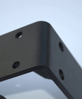 Close-up of Rock Solid Heavy Duty Metal Corner Brackets For Floating Shelves, matte black with pre-drilled holes.