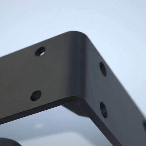 Close-up of Rock Solid Heavy Duty Metal Corner Brackets For Floating Shelves, matte black with pre-drilled holes.