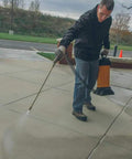 Man using a sprayer to apply Tough As Nails Penetrating Concrete Sealer For Driveways And Retaining Walls Breathable Moisture Shield.