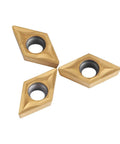 Three tungsten carbide DCMT070204 lathe inserts, diamond-shaped with center bore for metal cutting.