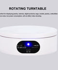 Motorized 360 Degree Rotating Turntable Stand For Jewelry Photography with power button and smooth surface.