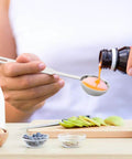 Pouring liquid into 5 Piece Measuring Spoons Set With 1/8 Tsp 1/4 Tsp 1/2 Tsp 1 Tsp And 1 Tbsp Stainless Steel Food Grade Kitchen Spoons