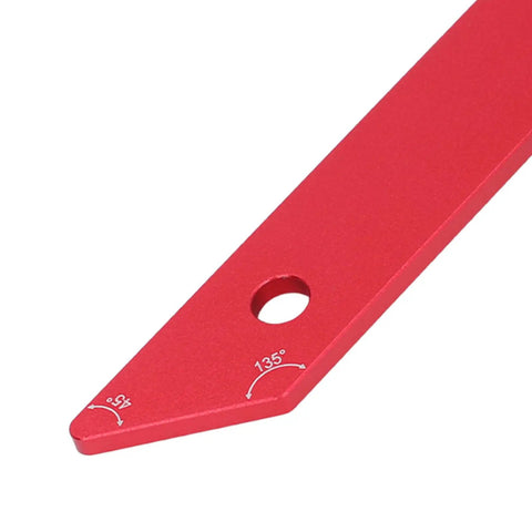 Red aluminum dual angle 45 and 135 degree woodworking ruler with etched marks and hole for precise miter cuts.