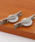 8 Pack Rock Hard Nylon Slider Wheel Replacement Pulleys for Walk in Closets Cabinet and Chiller Doors with white wheels on wood.