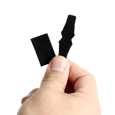 Hand holding Drop Away Arrow Rest Felt Kit with 2 pairs felt tapes and 2 arrow holder pads adhesive for compound bows.