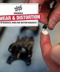Applying Heavy Duty Built Tough Bike Grease With High Pressure And Water Resistant Formula For Rust And Corrosion Protection Of Headsets Hubs And Bottom Brackets 3.5 Oz Ideal For Mountain And Road Bikes to bike component close-up.
