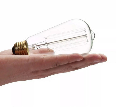 Person holding Vintage Style 25W Incandescent Clear Glass Bulbs For Home Lighting Amber Warm 2700K 110V 6 Pack
