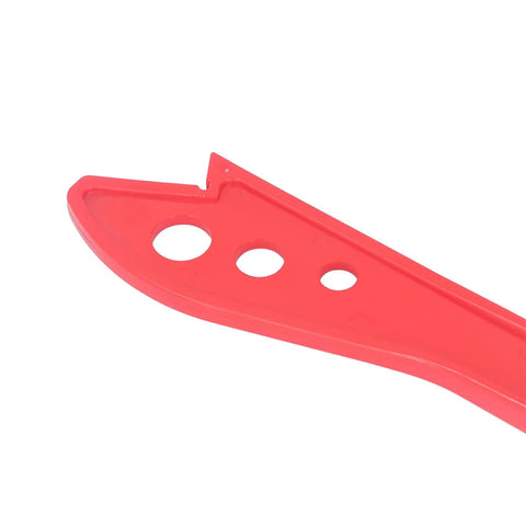 Close-up view of Workhorse Woodworking Safety Push Stick, red plastic with ergonomic design, ideal for guiding wood safely.