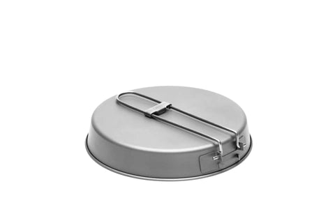 Ultralight Titanium Frying Pan 165mm D6.5 For Camping And Backpacking Featherlight Yet Durable Cast Iron Size Pan Rust Resistant Outdoor Cookware Under 3 Ounces Compact Space Saving Kitchen Essential showing bottom with folded handle.