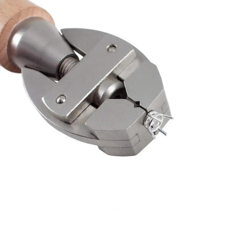 Solid Adjustable Hand Vise With Rotating Hardwood Handle That Snaps Securely And Grips Steady On Small Crafts Or Diy Builds Without Breaking A Sweat In Your Garage, showing jaws gripping small metal parts.