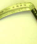 Curved metal tool with decorative engravings and wooden handle, different from Heavy Duty Pick Mattock For Tough Soil With Extra Thick Forged Steel