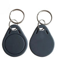 Two black fobs from 50 Pcs Pack Re-Writable RFID Hotel Key Fobs For 13.56MHz Locks, Compatible With RC522 PN532 Readers