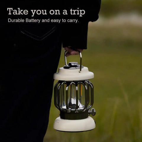 Person carrying a Led Camping Lantern With Rechargeable Battery And Retro Metal Construction for outdoor use