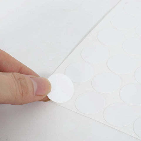 580 Piece Self Adhesive Screw Hole Stickers Set For Wooden Furniture And Cabinets, PVC Cover Caps Dustproof, 12mm 15mm 21mm, White, 6 Sheets, Easy Install For A Clean, Seamless Look shown close-up on white background with hand applying sticker