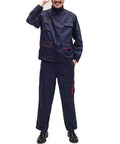 Mens Heavy Duty Long Sleeve Work Set With Strategic Multi Pocket Layout Durable Poly Cotton Blend Designed For The Daily Grind Kickass Shop Ready Uniform For Mechanics Engineers Welders worn by a smiling man standing.