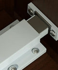 Heavy Duty Cabinet Door Push Latch With Magnetic Touch For Single Doors in white ABS plastic on wooden surface
