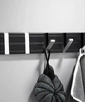 Next Level Wall Mounted Coat Hooks Solid Aluminum Robe Rack Quick Snap Install with three hooks holding towels and bags.