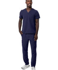 Mens Professional Medical Nursing Scrub Set Featuring Classic V Neck Top And Cargo Pants Crafted From Navy Blue No Drag Stretch Fabric Built Straight Up To Keep You Cool While Rocking Every Shift, model standing in navy scrub set.
