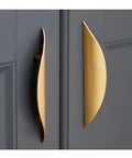 4 Pack Brushed Gold Crescent Cabinet Pulls with 5.79 Inch Overall Length and 3.75 Inch Hole Centers shown on dark cabinetry