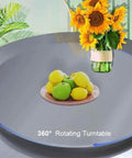 Slick Heavy Duty Stainless Steel Lazy Susan Rotating Turntable for Dining Tables with fruits and sunflowers displayed.