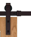 Close-up of 6.6 Ft Country Dark Coffee Steel Sliding Barn Door Hardware Set for Doors and Closets with Antique Finish installed on wood door.