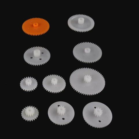 Assortment of white and orange plastic gears from Awesome 200 Piece Plastic Gear Set For DIY Robots And Toys Including Crown Gears, Spur Gears.