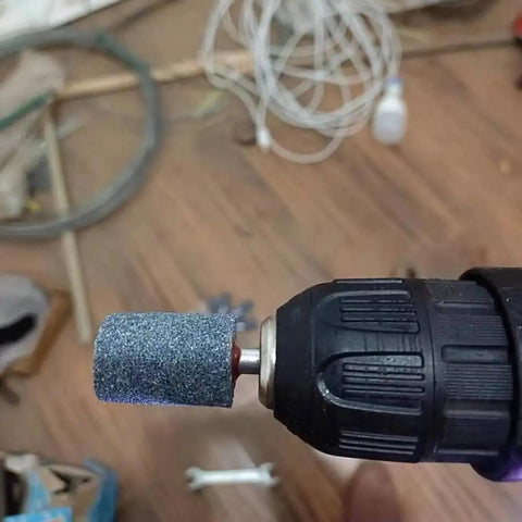 Close-up of Ten Pcs 20 Millimeter Aluminum Oxide Mounted Grinding Stones Rotary Grinding Bits With One Quarter Inch Shank on drill.