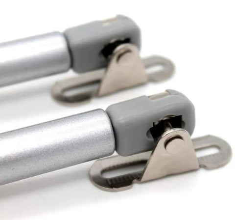 2 Pack Heavy Duty Gas Struts Rock Solid Soft Close Lift Supports close-up of zinc plated ends and gray connectors.