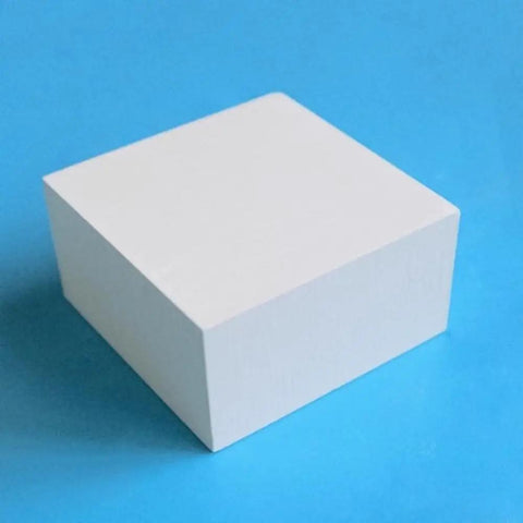 Boron Nitride Ceramic Sheet Pad And Plate For Heat Proof Performance, Nonstick Surfaces, Low Friction, shown from a side angle on blue background.