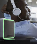 Person relaxing with headphones, next to Wireless Doorbell 9 Series With Push Button Blue Grey Portable Chime Adjustable Volume