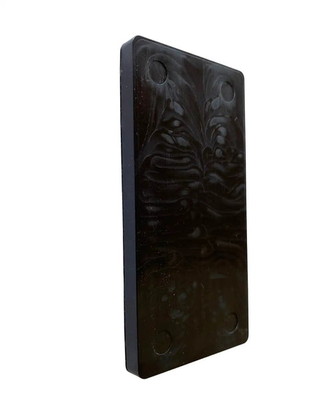 Hella Tough Quarter Inch Black Plastic Flat Plate Shim standing vertically, essential for cabinet leveling and tile spacing.