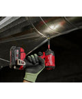 Hand holding a drill fitted with Shockwave 3/4 Inch Drive Impact Duty Socket With Ball Detent And Dual Hole Groove on metal duct.