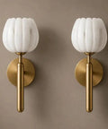 Modern Brushed Brass Wall Sconce Light - Fluted Alabaster Glass Shade Wall Mounted Lamp showcased on a wall with neutral backdrop.