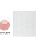 Sheet of Self Adhesive No Slip Transparent Rubber Buffer Pads For Tables, Chairs, Photo Frames And Furniture, close-up on finger.