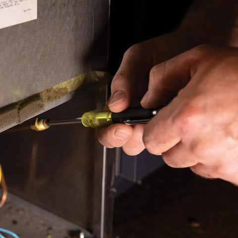 Person using HVAC Tool Kit With 3 In 1 Pocket Screwdriver for quick HVAC repairs on equipment.
