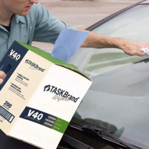 Person using Blue V40 Value Series Center Pull Wiper Sheets All Purpose Disposable Cleaning Towels 10 X 11.5 Inches Roll Of 200