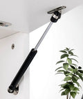40N 8.8lb Gas Struts Lift Supports for cabinets in black, mounted on a white cabinet lid, showcasing soft open lid stay.