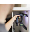 Rugged 18V Cordless Drill With Keyless Chuck And Belt Clip Compact Ergonomic Handle used for fastening inside a cabinet.