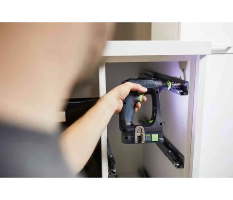 Rugged 18V Cordless Drill With Keyless Chuck And Belt Clip Compact Ergonomic Handle used for fastening inside a cabinet.