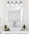 Sleek Chrome Finish Four Light Bathroom Vanity Light Fixture With Clear Glass Shades above a modern bathroom sink